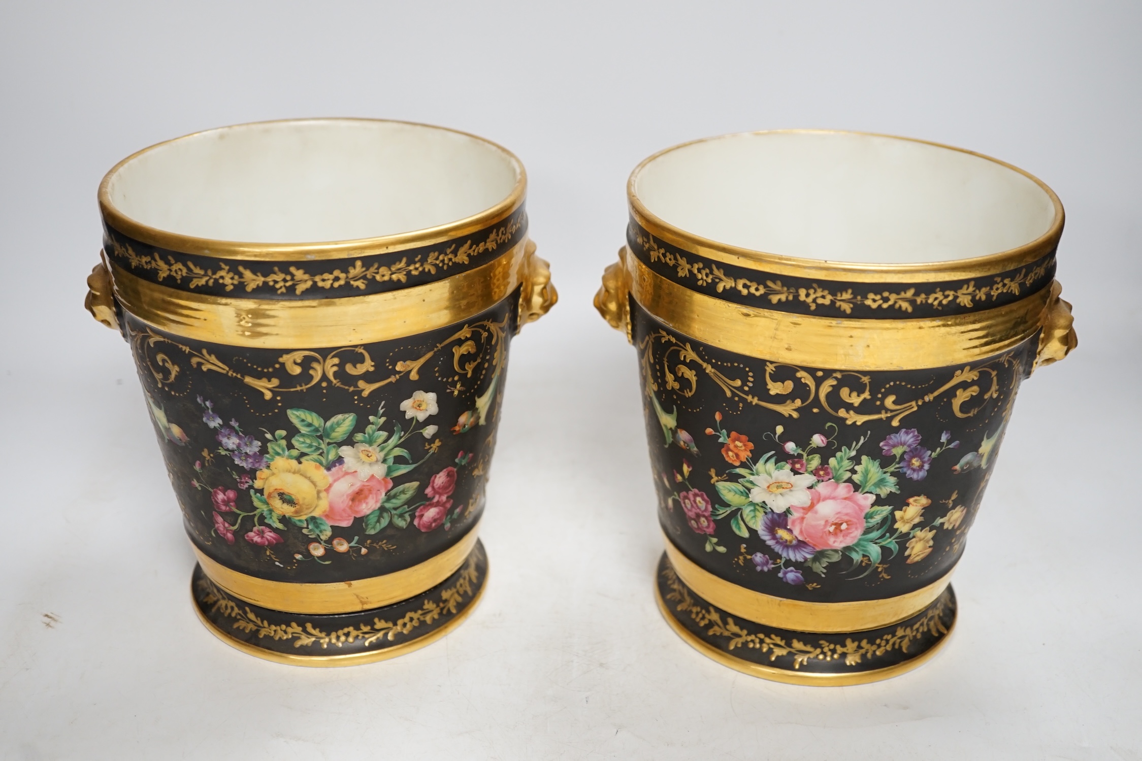 A pair of Paris porcelain cache pots and under dishes, black ground, floral and gilt decoration, 18.5cm high. Condition - both have wear to gilding and black ground, one pot has a star crack to base
